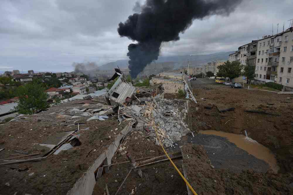 The aftermath of shelling during fighting between Armenia and Azerbaijan over the breakaway Nagorno-Karabakh region, in the disputed region's main city of Stepanakert on Sunday. (AFP)