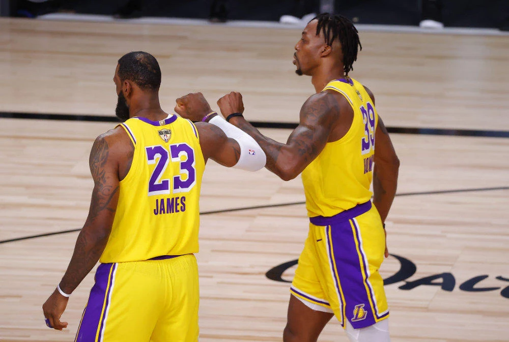 LeBron James #23 and Dwight Howard #39 react during the first quarter against the Miami Heat in Game One of the 2020 NBA Finals at the ESPN Wide World Of Sports Complex on September 30, 2020 in Lake Buena Vista, Florida. (Kevin C. Cox/Getty Images/AFP)