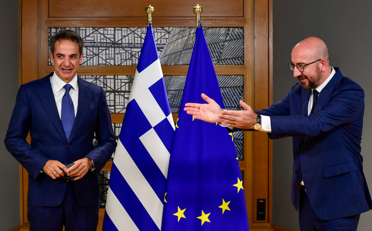 European Council President Charles Michel, right, greets Greek Prime Minister Kyriakos Mitsotakis ahead of a meeting on the sidelines of an EU summit at the European Council building in Brussels, Thursday, Oct. 1, 2020. (AP)