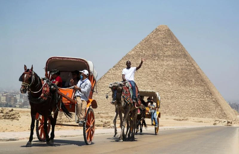 Tourists and guides at the Great Pyramid of Giza, Cairo, Egypt, July 1, 2020. (Reuters)