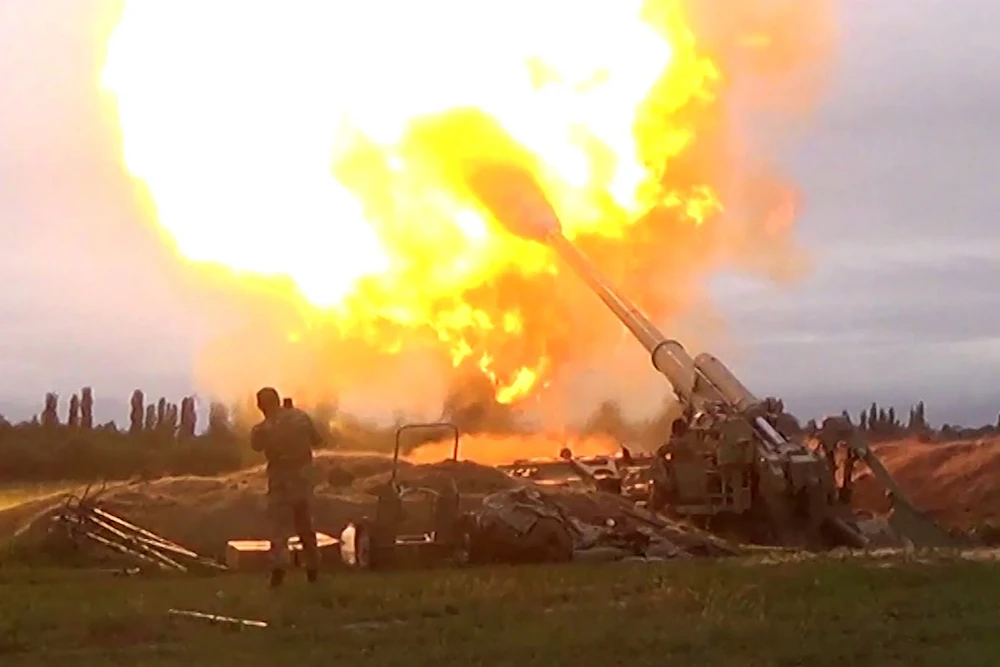 An image grab taken from a video made available on the official web site of the Azerbaijani Defence Ministry on September 28, 2020, allegedly shows Azeri artillery strike towards the positions of Armenian separatists in the breakaway region of Nagorno-Karabakh. (AFP/Azerbaijani Defence Ministry)