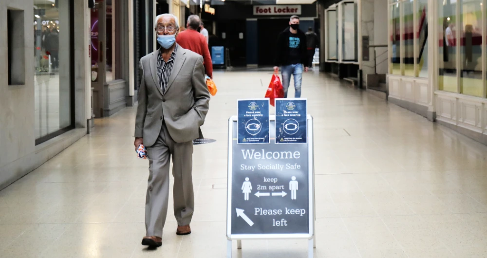A man wearing a face mask walks in a shopping centre amid the outbreak of the coronavirus disease (COVID-19), in Chester, Britain. (Reuters)