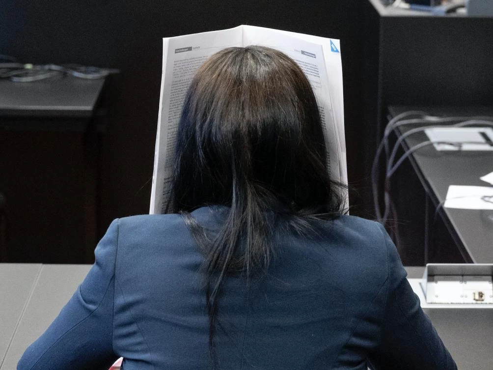 The widow of the Berlin rapper and later Daesh member Denis Cuspert sits in a courtroom in the district court at the beginning of a trial. (File/AP)