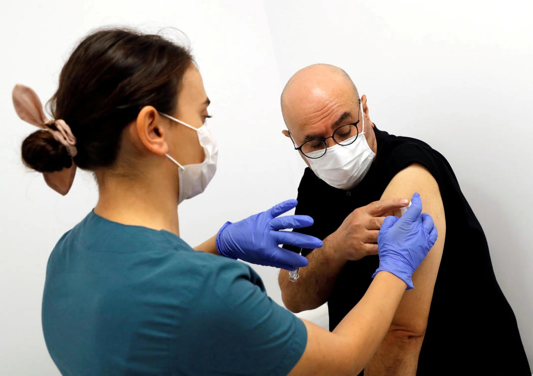 A health worker injects an experimental COVID-19 vaccine to a volunteer as Turkey began final Phase III trials at Kocaeli University Research Hospital in Kocaeli, Turkey. (File/Reuters)