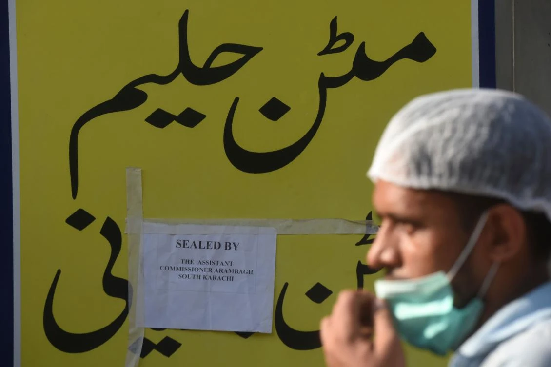An employee walks past a closed restaurant after been sealed by authorities for violating Covid-19 Coronavirus prevention guidelines, in the Pakistan's port city of Karachi on October 2, 2020. (AFP)
