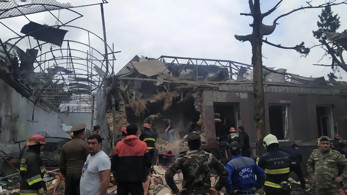 Emergencies personnel work in a damaged area of the city of Ganja following a reportedly Armenian rocket strike on Sunday. (AFP)