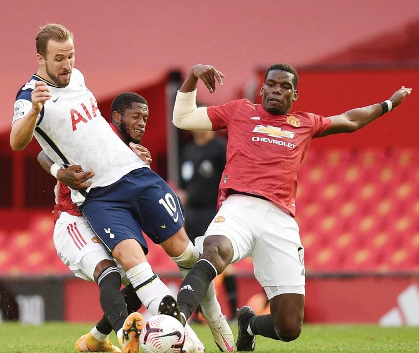 Tottenham Hotspur’s Harry Kane in action with Manchester United’s Paul Pogba and Fred Pool during their match in Old Trafford, Manchester, on Sunday. (Reuters)