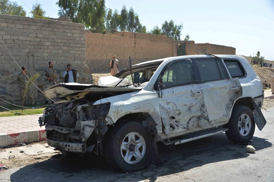 Afghan security forces inspect the site of a car bomb attack that targeted Laghman provincial governor’s convoy in Mihtarlam, Laghman province on October 5, 2020. (AFP)