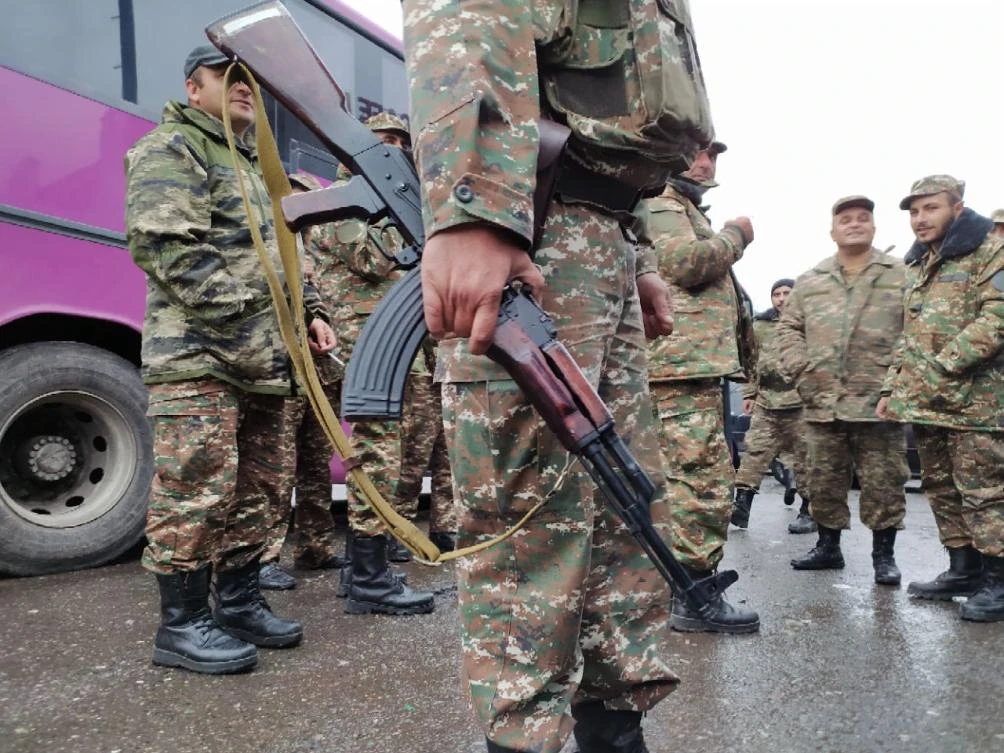 Ehtnic Armenian volunteers and reservists get ready to be deployed toward the Karabakh frontline to fight with Azeri troops on Oct. 6, 2020. (AFP)
