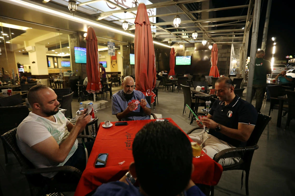 People play cards at a cafe, amid fears of a rising number of coronavirus disease (COVID-19) cases in Amman, Jordan October 7, 2020. (Reuters)