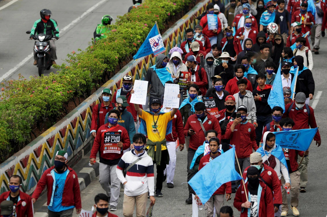 Indonesian labor unions march on a main road towards the Presidential Palace during a strike to protest against the government's labour reforms in a controversial jobs creation law in Jakarta, Indonesia, October 8, 2020. (Reuters)