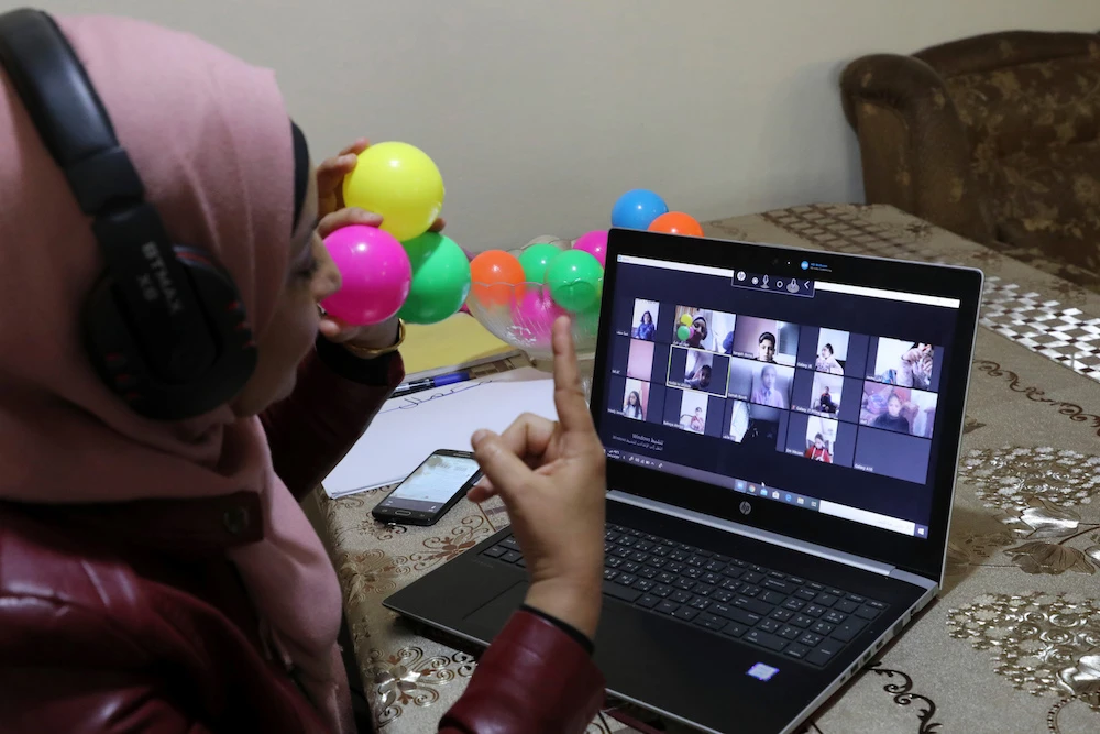 This picture taken on March 23, 2020 shows Palestinian teacher Jihad Abu Sharar presenting an online class from her home in the village of Dura near Hebron in the occupied West Bank, after schools were closed as a preventive measure against the spread of the COVID-19 novel coronavirus. (AFP/File Photo)