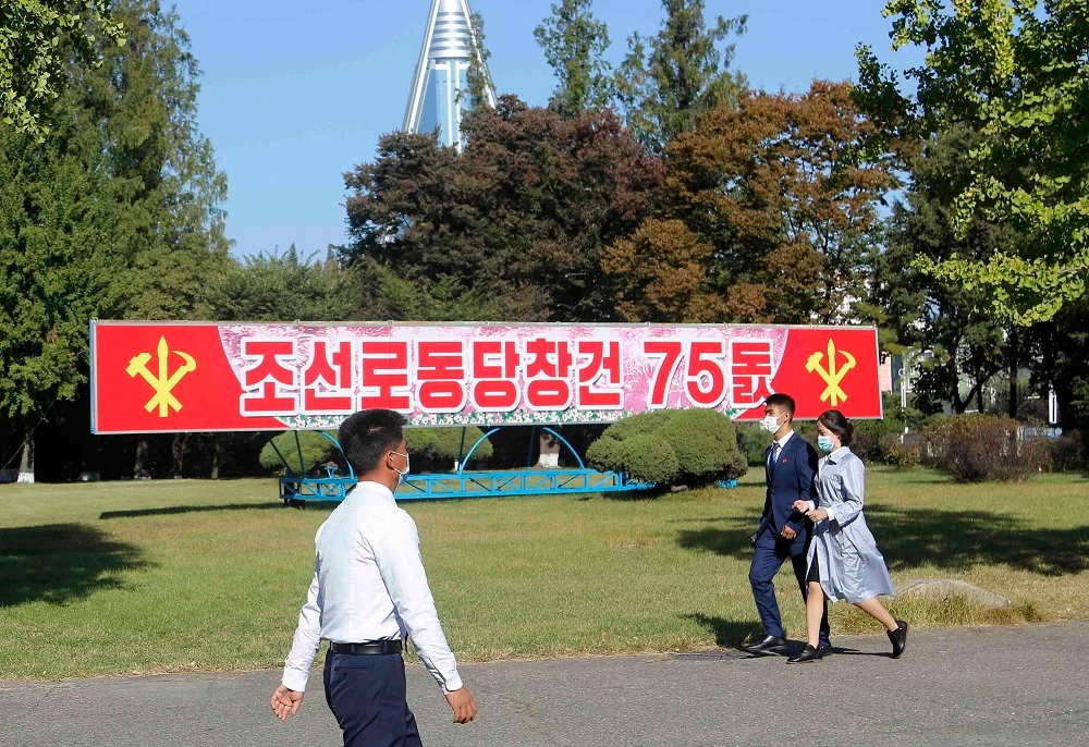 People walk past a banner that says ‘75th founding anniversary of the Workers’ Party of Korea,’ in Pyongyang on Oct. 10, 2020 as North Korea celebrate anniversary of the country’s ruling party. (AP)