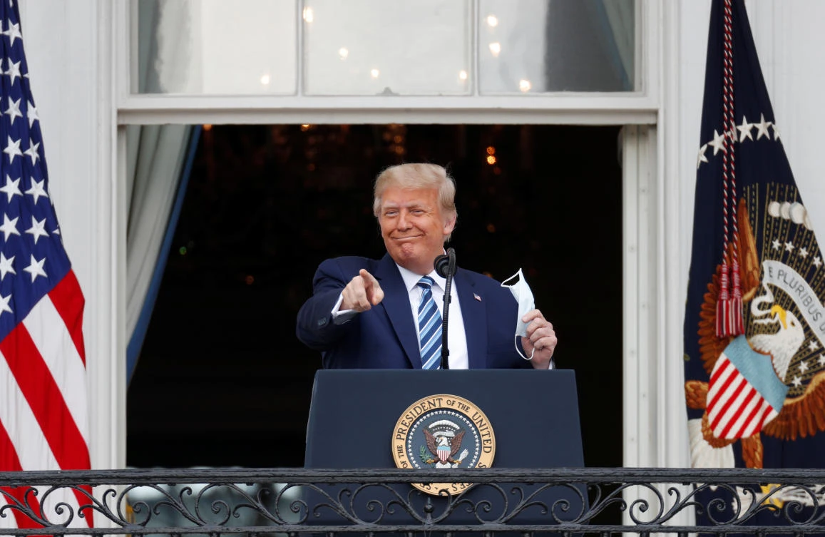 US President Donald Trump gestures as he stands on a White House balcony speaking to supporters gathered for a campaign rally that the White House is calling a “peaceful protest” in Washington, US, Oct. 10, 2020. (Reuters)