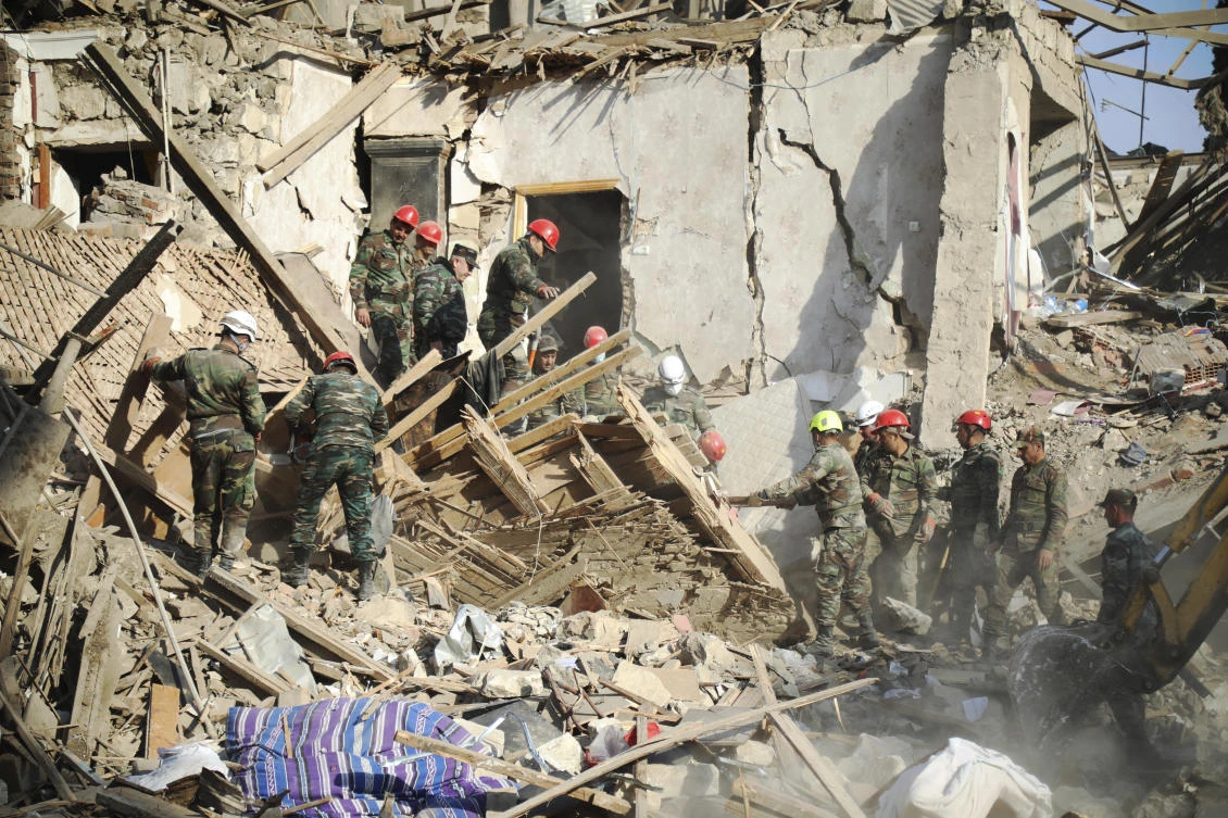 Rescuers work at the scene of damage after shelling by Armenian's artillery during fighting over the separatist region of Nagorno-Karabakh, in Ganja, Azerbaijan, Sunday, Oct. 11, 2020. (AP)