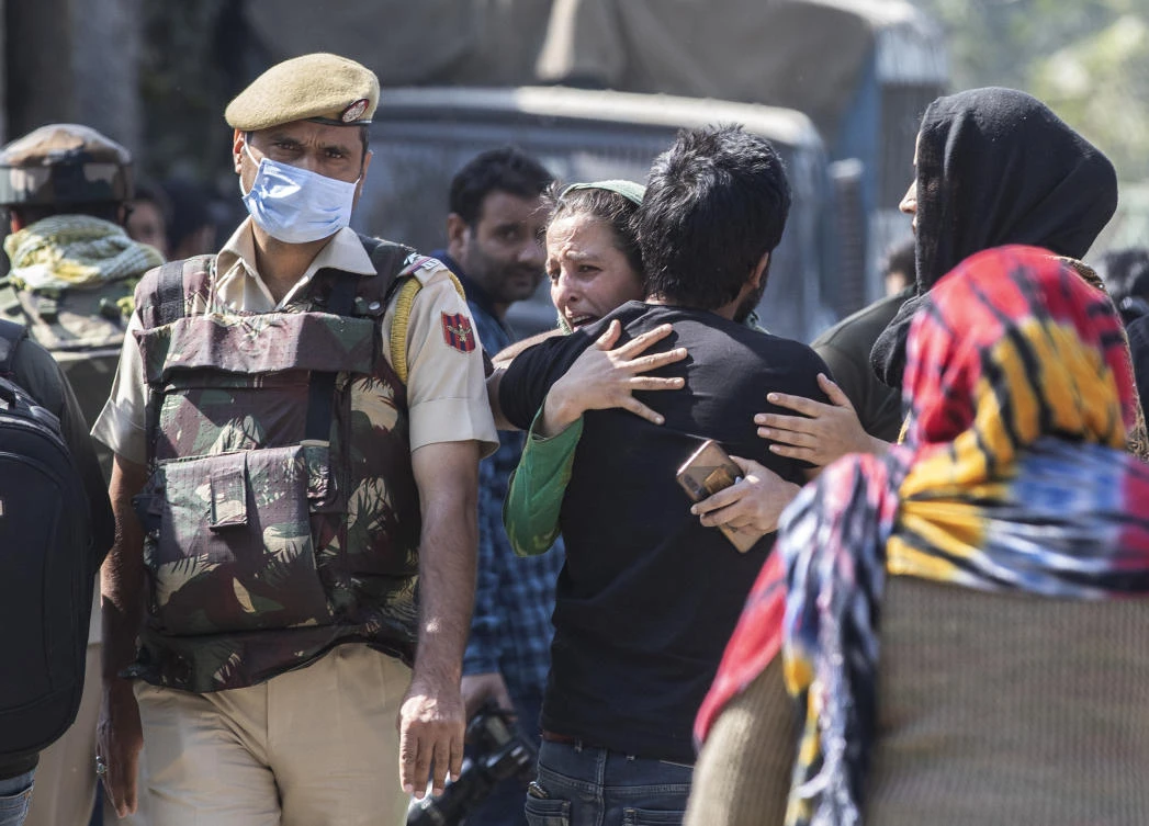 A Kashmiri woman weeps as she hugs a relative after the killing of two suspected rebels in a gunfight with government forces in Srinagar, Indian controlled Kashmir, Monday, Oct. 12, 2020. (AP)