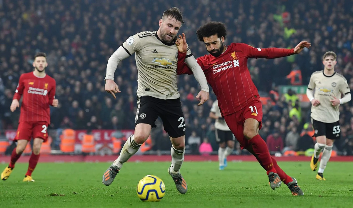 Liverpool's Egyptian midfielder Mohamed Salah (R) battles with Manchester United's English defender Luke Shaw (L) during the English Premier League football match at Anfield stadium in Liverpool. (AFP/File)