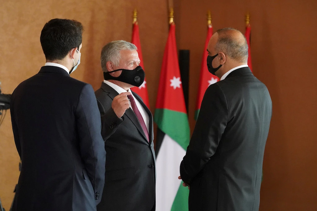 Jordan's King Abdullah and Crown Prince Hussein talk to newly-appointed Prime Minister Bisher al Khasawneh during a swearing-in ceremony of the new government in Amman, Jordan October 12, 2020. (Reuters)