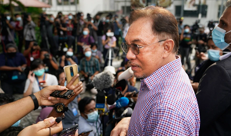Malaysian opposition leader Anwar Ibrahim speaks to media after leaving the police headquarters in Kuala Lumpur, Malaysia, Friday, Oct. 16, 2020. (AP)
