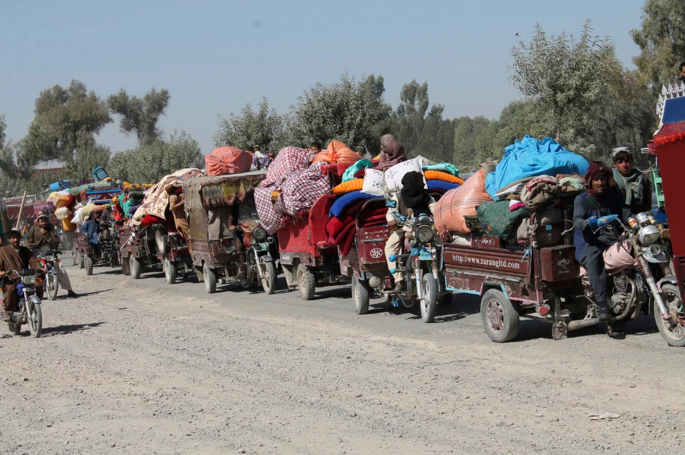 Afghan families leave their houses after fighting between the Afghan military and Taliban insurgents in Helmand province on Oct. 13, 2020. (AP Photo/Abdul Khaliq)