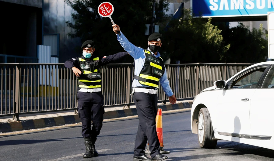 Jordanian police personnel guard at a checkpoint during the second day of a nationwide curfew, imposed for two days, amid fears of a rising number of coronavirus disease (COVID-19) cases in downtown Amman, Jordan October 17, 2020. (REUTERS)