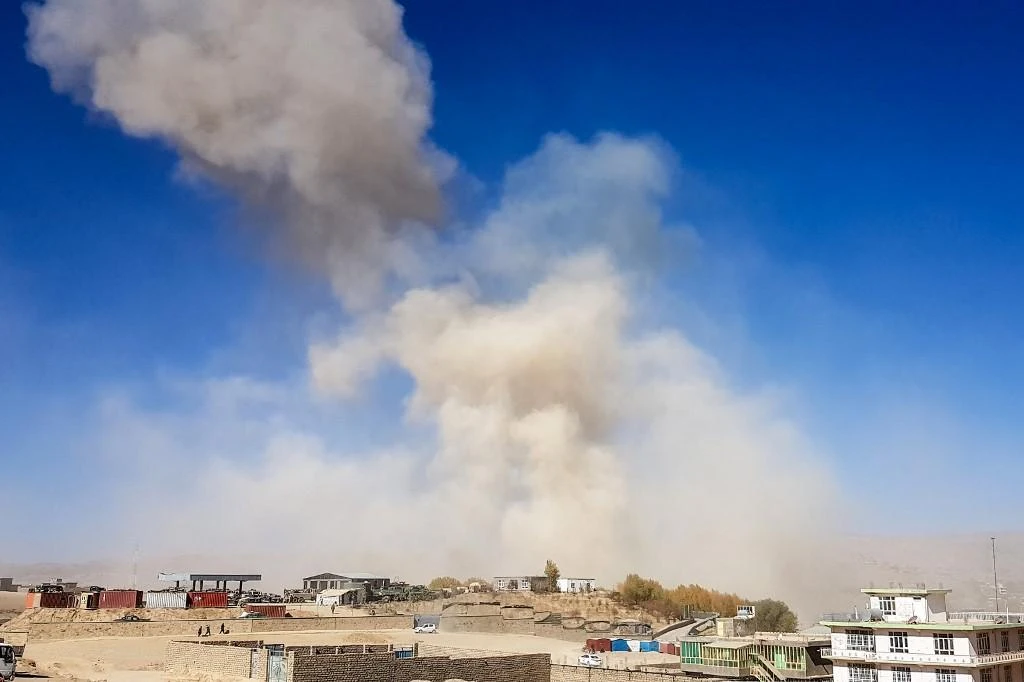 Smoke rises from the site of a car bomb attack that targeted an Afghan police headquarters in Feroz Koh, the capital of Ghor Province on October 18, 2020. (AFP)