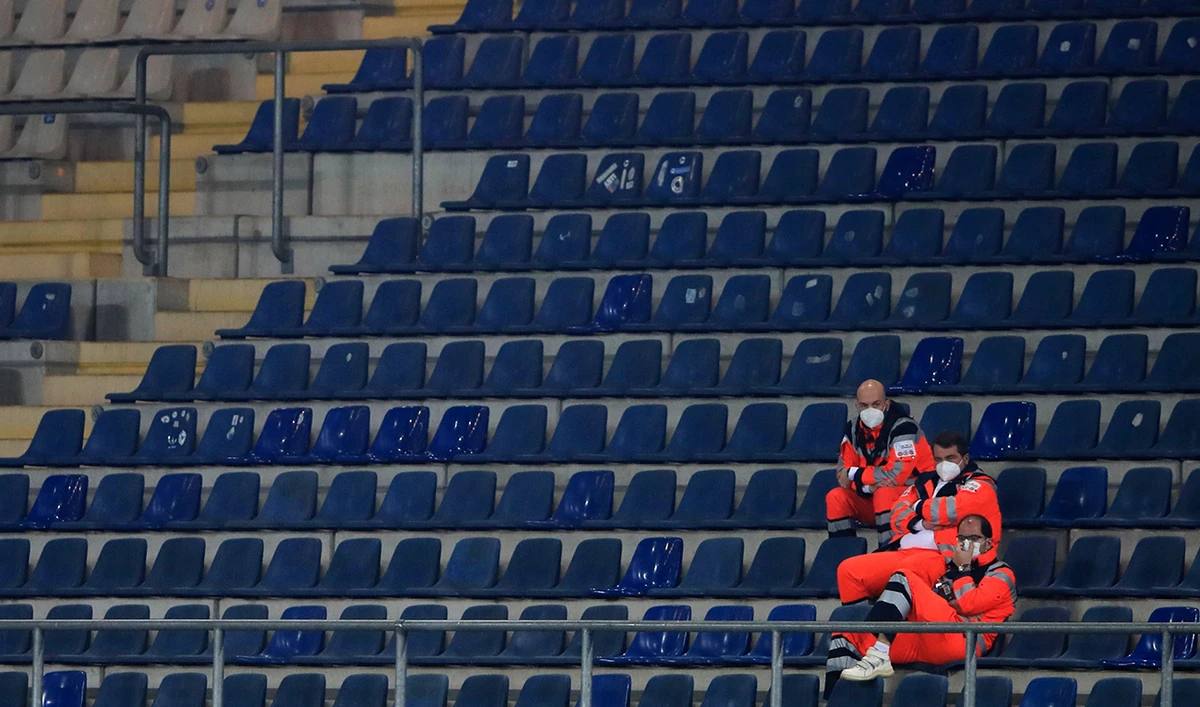 Medical staff wearing face masks look on from the stands during the German first division Bundesliga football match in Bielefeld, western Germany, on October 17, 2020. (AFP)