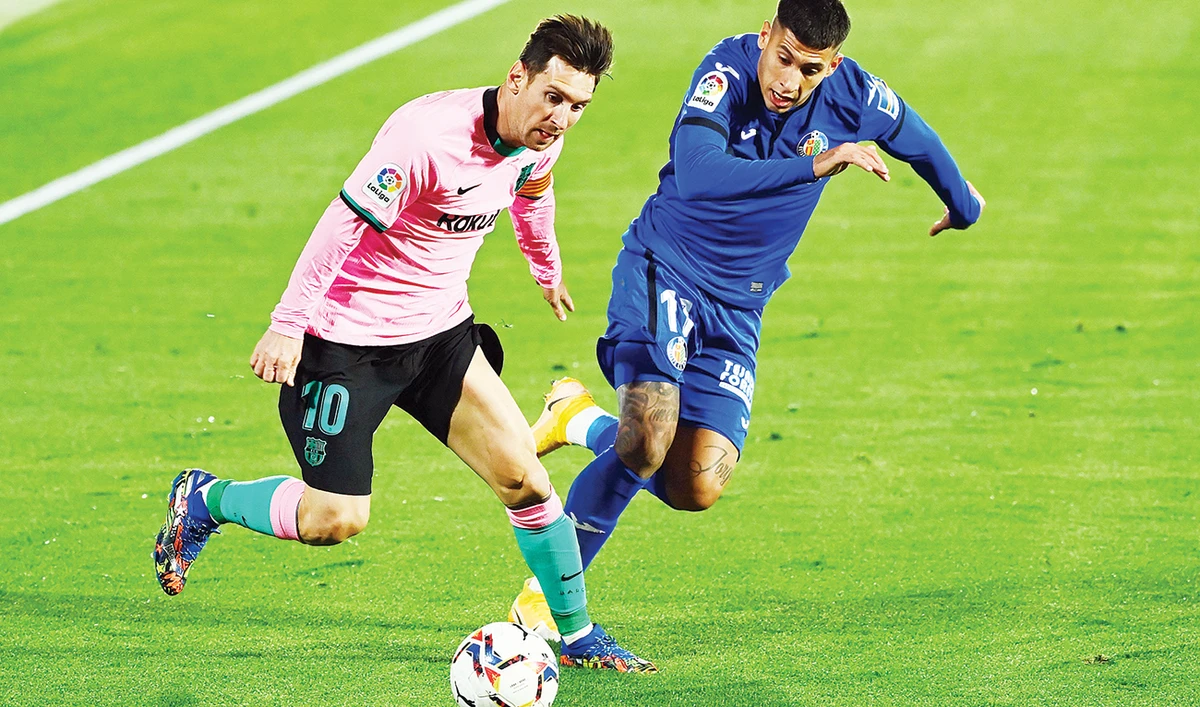 Barcelona’s Argentine forward Lionel Messi, left, and Getafe’s Uruguayan defender Mathias Olivera during the Spanish League match on Saturday. (AFP)