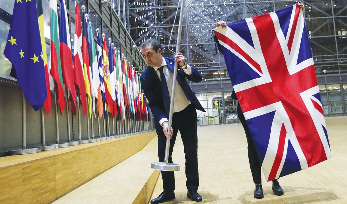 Officials remove the British flag at European Union Council in Brussels. Britain is urging businesses to step up preparations for a no-deal departure from EU. (Reuters/File)