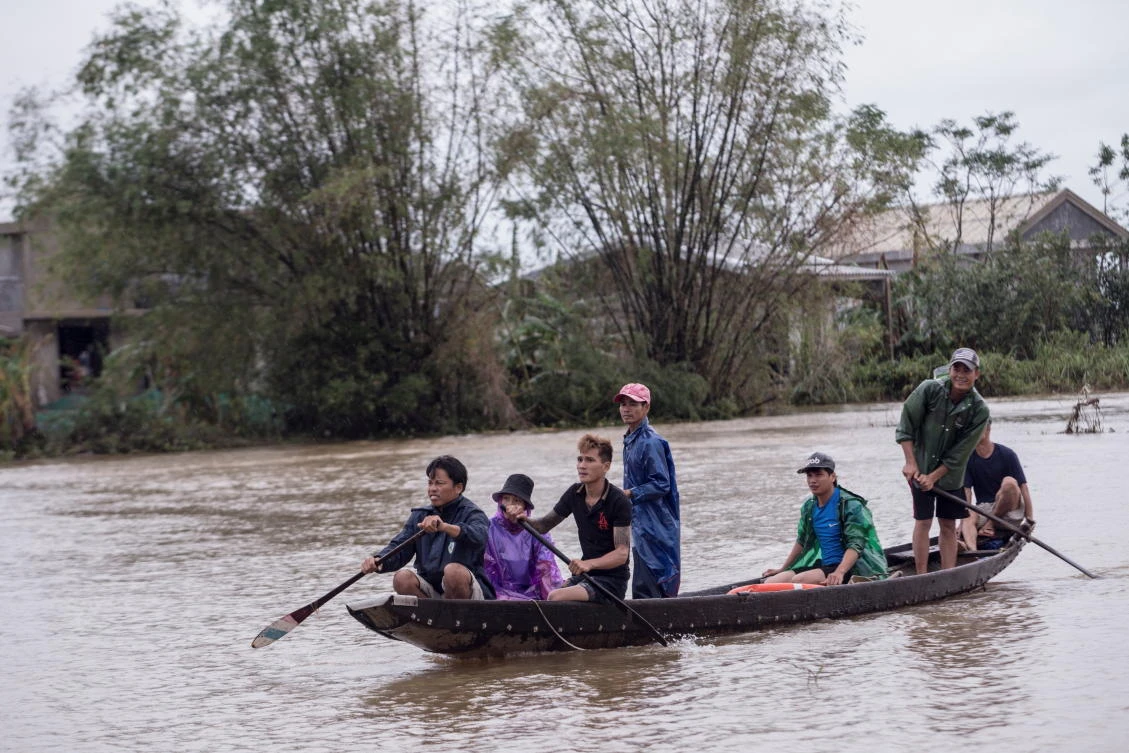 Local residents row a boat to a pickup point for delivering aid packages to residents affected by heavy flood in Quang An Commune, Thua Thien Hue, Vietnam on Oct. 20, 2020. (International Federation of the Red Cross via Reuters)