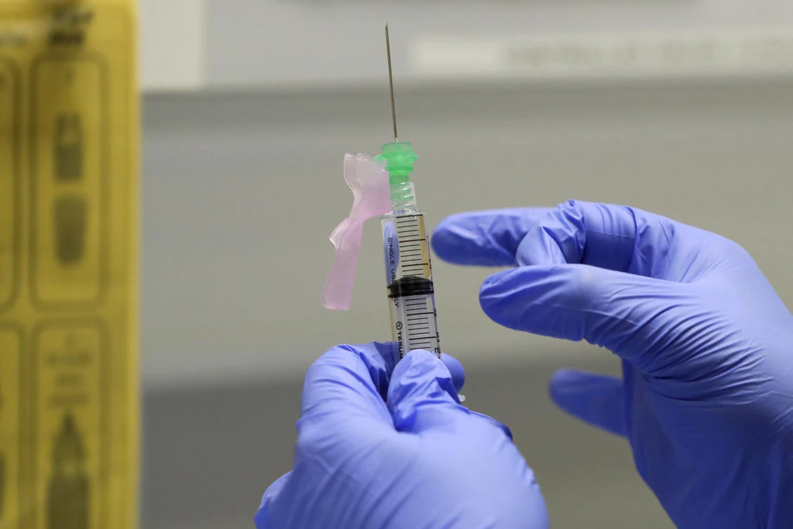 In this Wednesday, Aug. 5, 2020 file photo, senior Clinical Research Nurse Ajithkumar Sukumaran prepares the COVID-19 vaccine to administer to a volunteer, at a clinic in London. (AP)