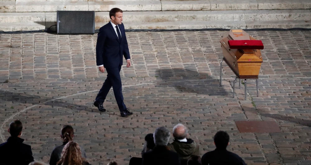 A ceremonial military guard carried the teacher’s coffin into the cobblestone courtyard of the Sorbonne. (Reuters)