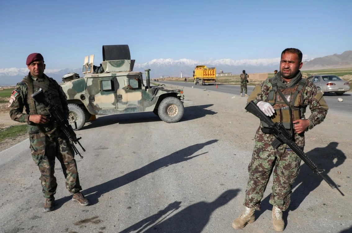 Afghan National Army (ANA) soldiers stand guard at a checkpoint near Bagram Air Base, north of Kabul, April 2, 2020. (Reuters)