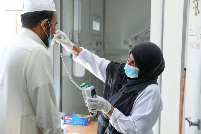 Stern warning. A Saudi nurse checks a patient's temperature at a mobile clinic in the holy city of Mecca, April 7. (AFP)