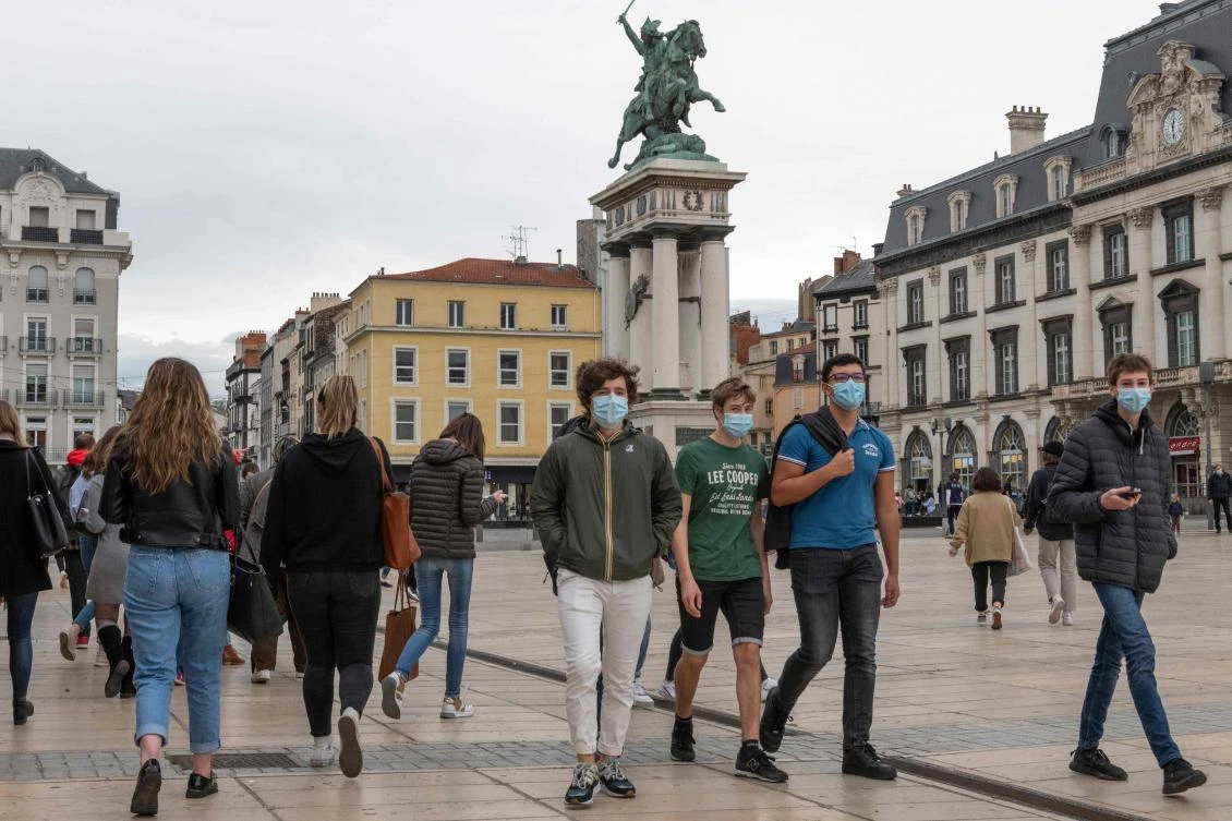 People walk on Place de Jaude in Clermont-Ferrand on October 22, 2020. (AFP)