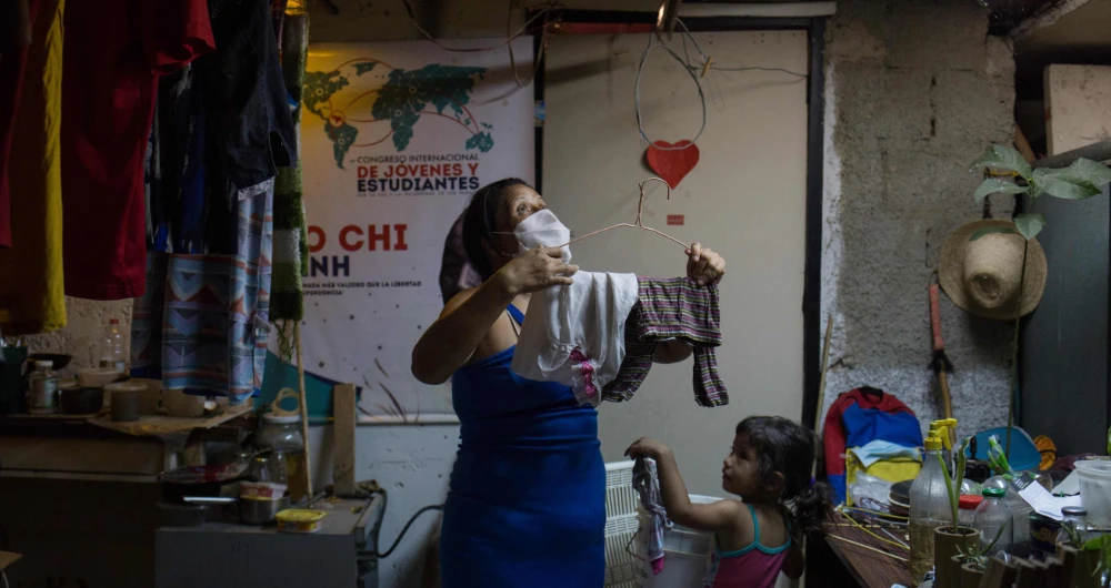 Fourteen families live without electricity, ventilation, running water or bathrooms in the basement of a government building in Caracas, which makes them specially vulnerable to the coronavirus. (AFP)