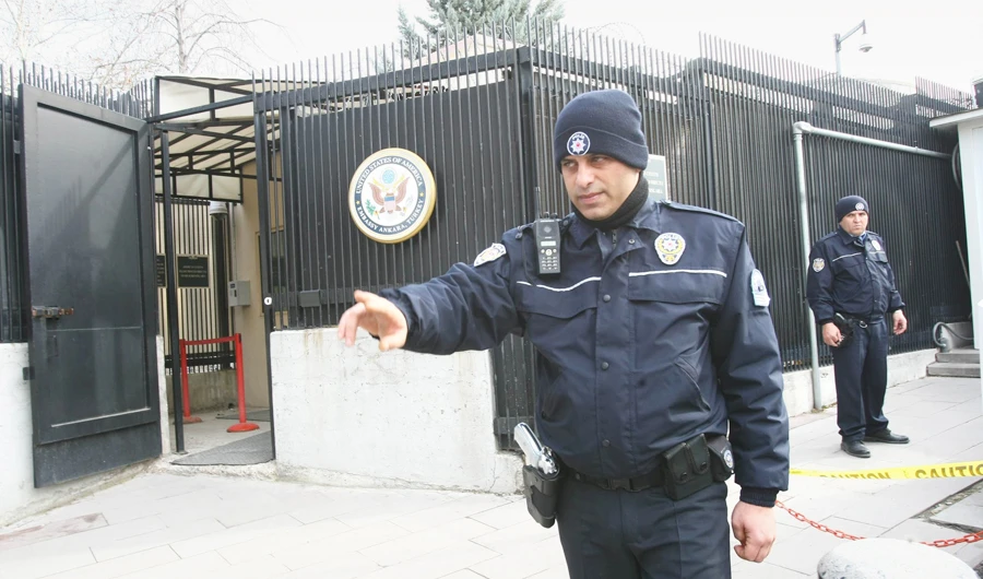 Turkish police officers patrol near the side entrance of the US Embassy in Ankara, after it suspended its visa services on Friday. (AFP/File)