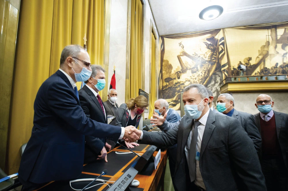 Representatives of Libya’s two rival factions shake hands after signing a ‘permanent’ cease-fire agreement following the five-day talks at the UN. (AFP)