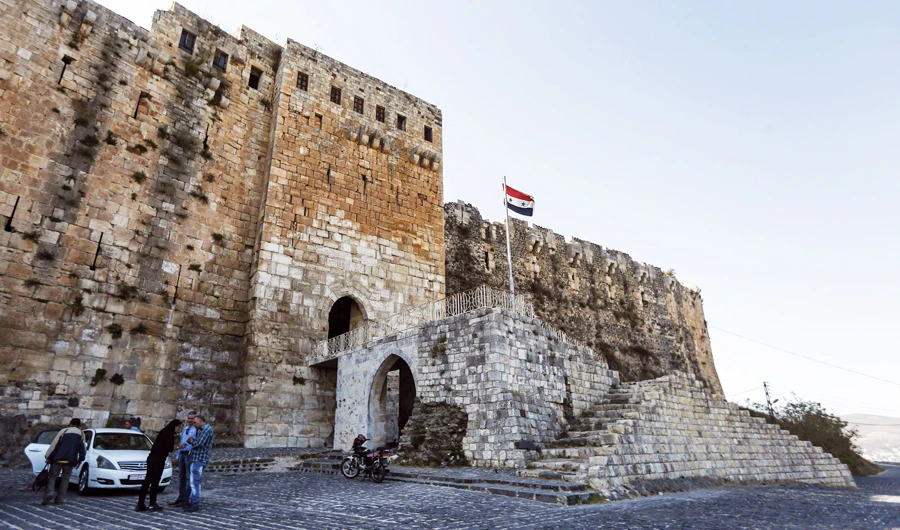 A Syrian flag flying by a gate at the walls of the medieval Crusader fortress Krak des Chevaliers, some 40 km west of city of Homs and close to the border with Lebanon. (AFP)