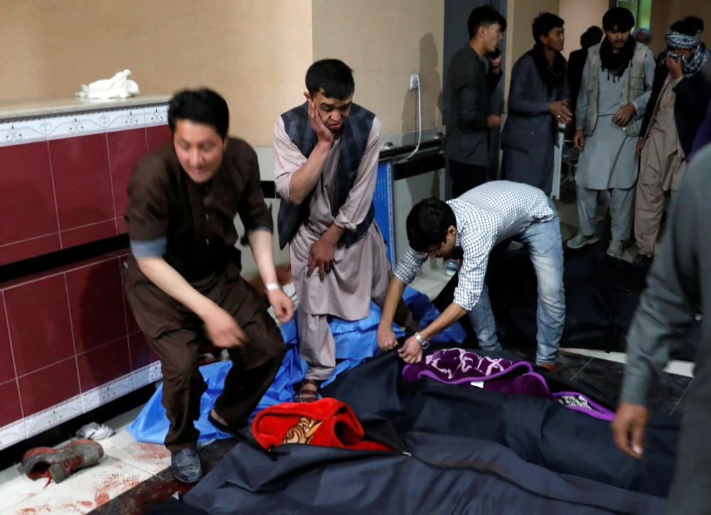 Afghan men look for their relatives at a hospital after a suicide bombing in Kabul, Afghanistan, on Oct. 24, 2020. (REUTERS/Mohammad Ismail)
