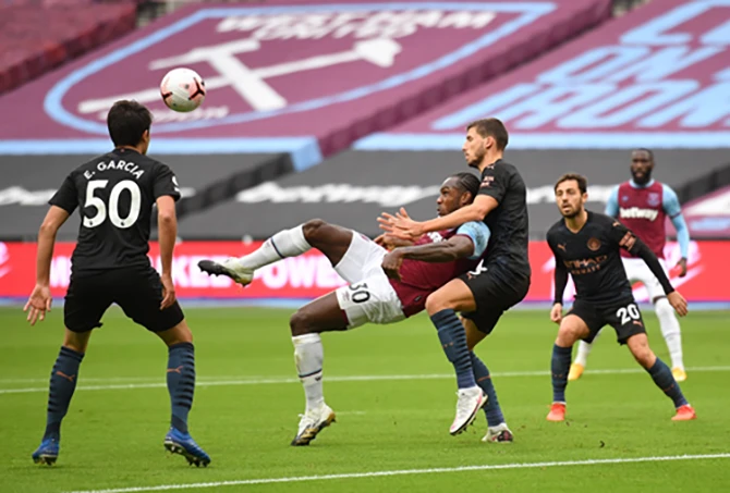 West Ham United’s midfielder Michail Antonio scores the opening goal during Saturday’s English Premier League football match against Manchester City in London. (AFP)