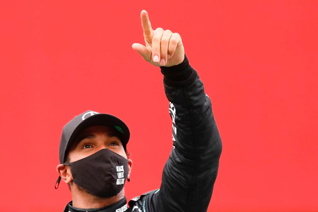 Mercedes' British driver Lewis Hamilton celebrates on the podium after winning the Portuguese Formula One Grand Prix at the Autodromo Internacional do Algarve on October 25, 2020 in Portimao. (AFP)
