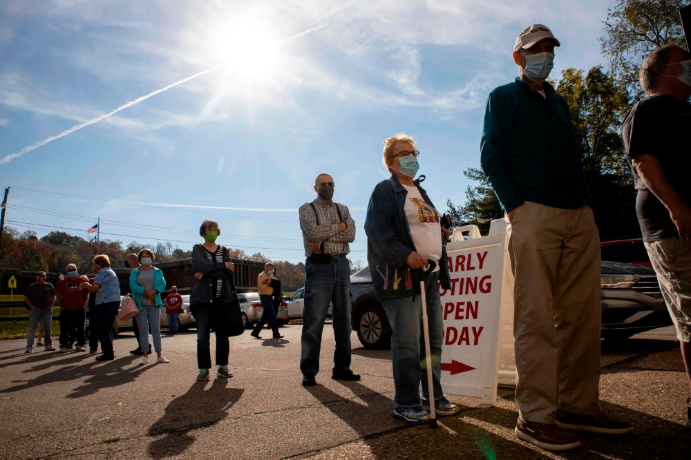 In this file photo taken on October 21, 2020, early voters line up outside of the Vienna Community Building to cast their ballots for the November 3 election, in Vienna, West Virginia. (AFP / Stephen Zenner)