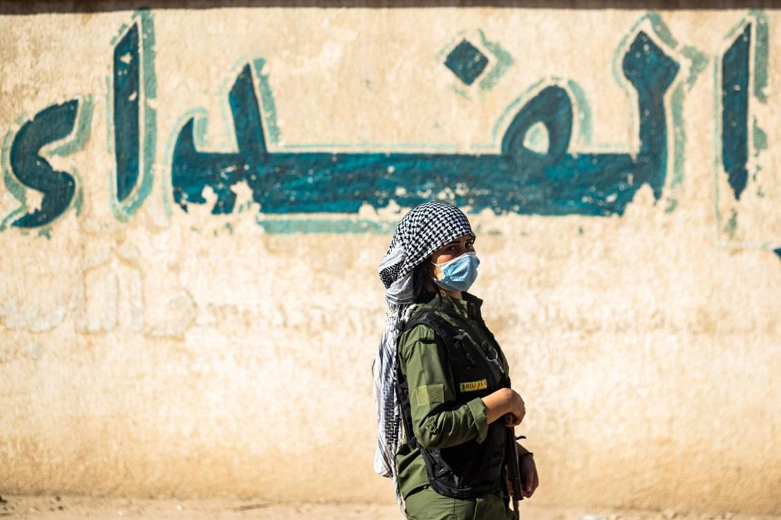 A fighter stands guard during a rally to denounce the recent attacks by Turkish forces on northeastern Syria on Oct. 24, 2020. (AFP)