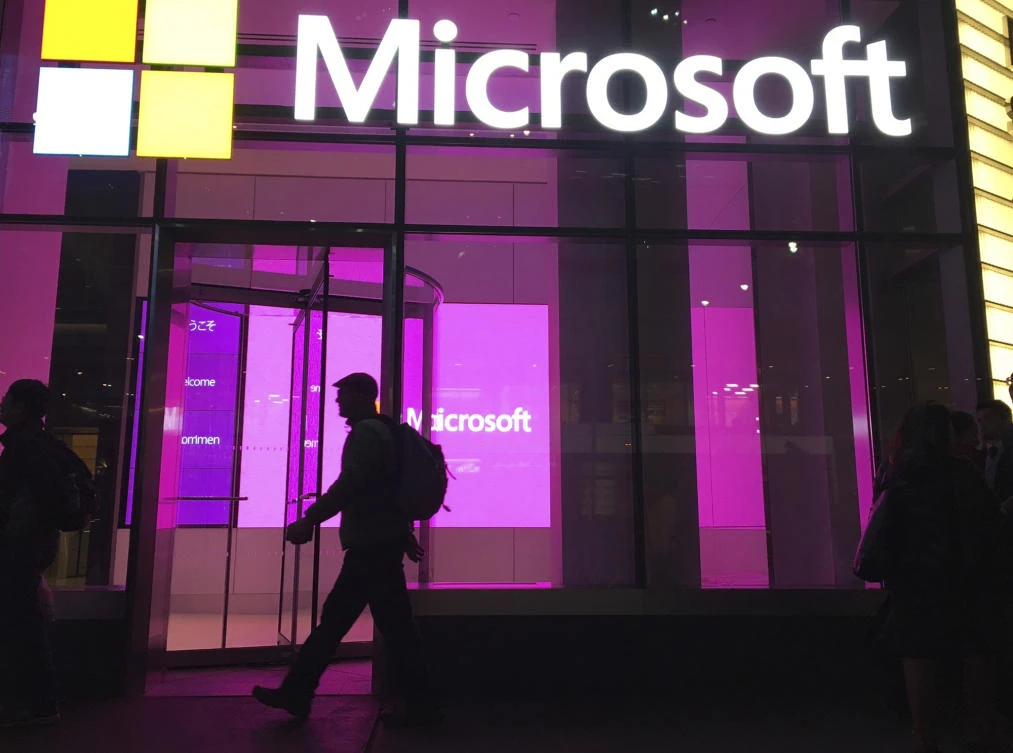 In this Nov. 10, 2016, photo, people walk near a Microsoft office in New York. Microsoft says Iranian hackers have posed as conference organizers in Germany and Saudi Arabia in an attempt to spy on “high-profileâ€' people using spoofed email invitations. (AP)