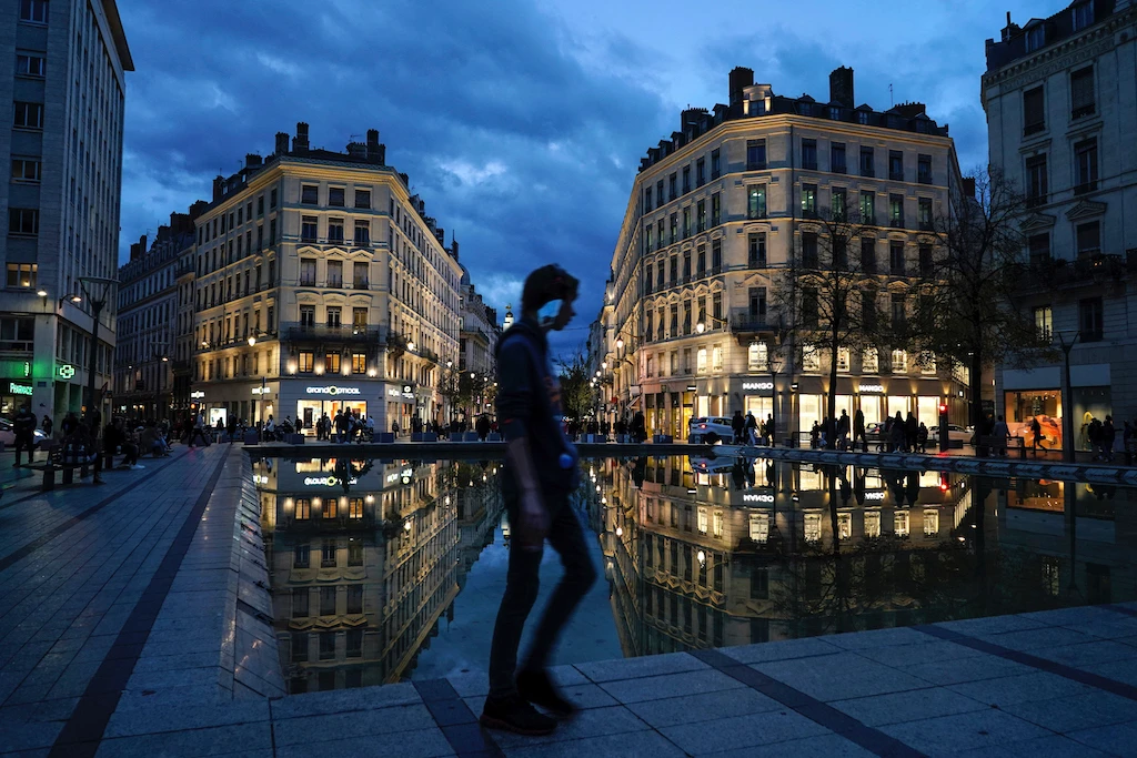 A man wearing a mask walks in the street in the center of Lyon, central France, Wednesday, Oct. 28, 2020. France is bracing for a potential new lockdown as the president prepares a televised address Wednesday aimed at stopping a fast-rising tide of virus patients filling French hospitals and a growing daily death toll. (AP)