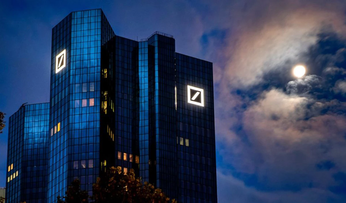 The moon shines next to the headquarters of the Deutsche Bank in Frankfurt, Germany, early Sunday, Oct. 4, 2020. (AP)