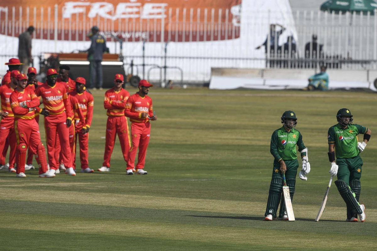 Pakistan's Imam-ul-Haq (R) and Pakistan's Abid Ali wait for a third umpire decision during the first one-day international (ODI) cricket match between Pakistan and Zimbabwe at the Rawalpindi Cricket Stadium in Rawalpindi on October 30, 2020. (AFP)