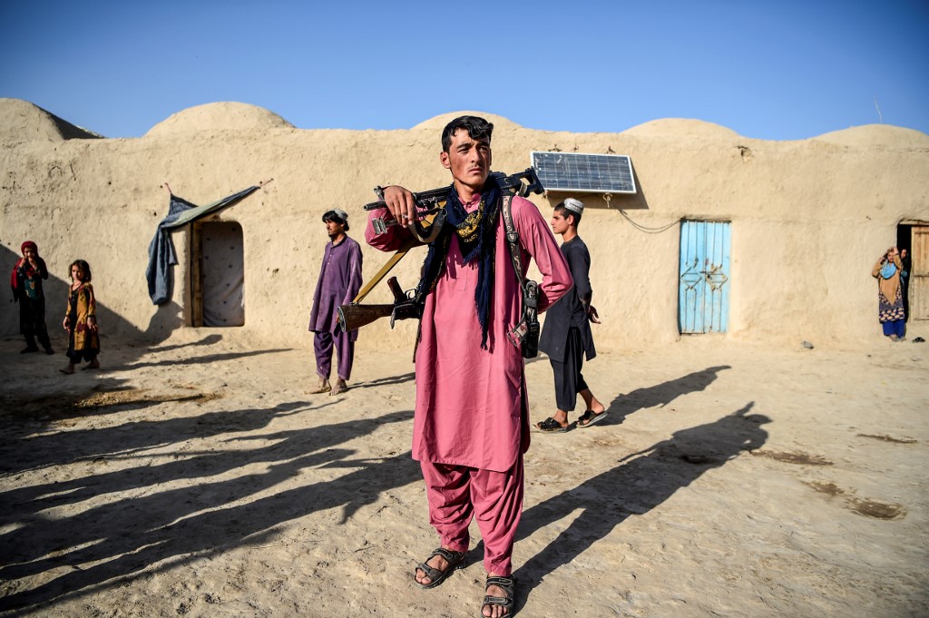 An Afghan policeman guards the courtyard of a house at Deh Qubad village in Maiwand district of Kandahar province. (AFP/File)
