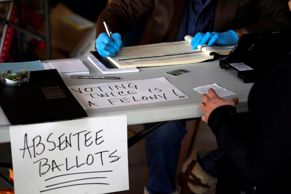 A voter cancels their absentee ballot so that they may vote in person at African American Heritage Center during the 2020 US presidential election in Louisville, Kentucky, US Nov. 3, 2020. (Reuters)